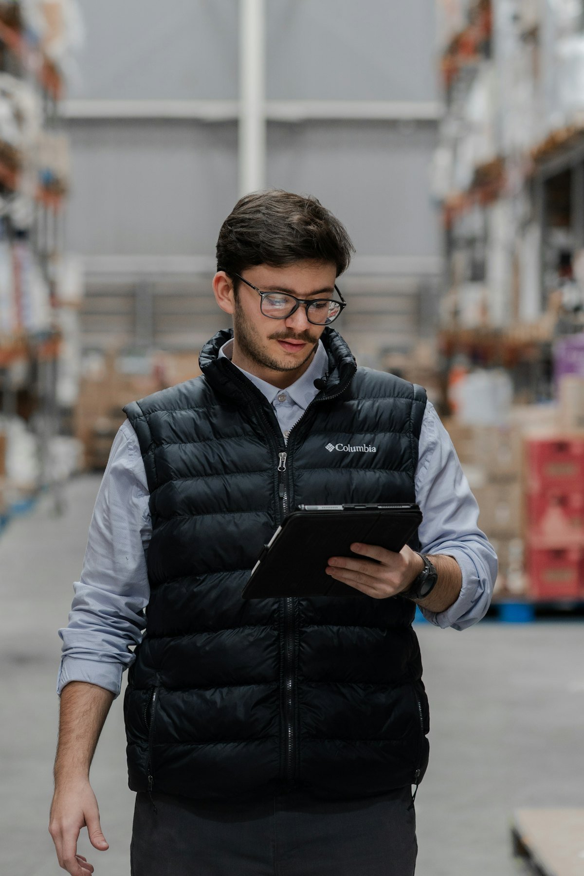 Warehouse manager checking stock on a tablet