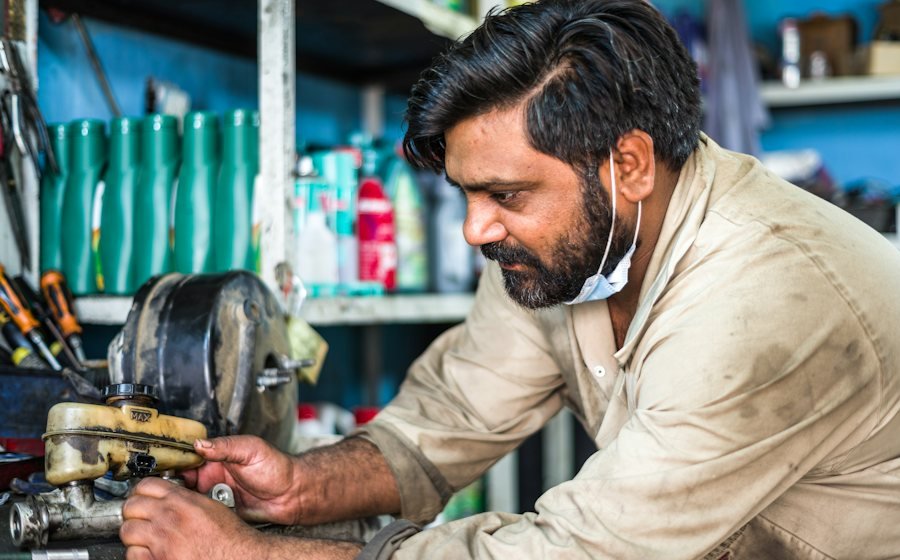 Technician servicing equipment with a power tool